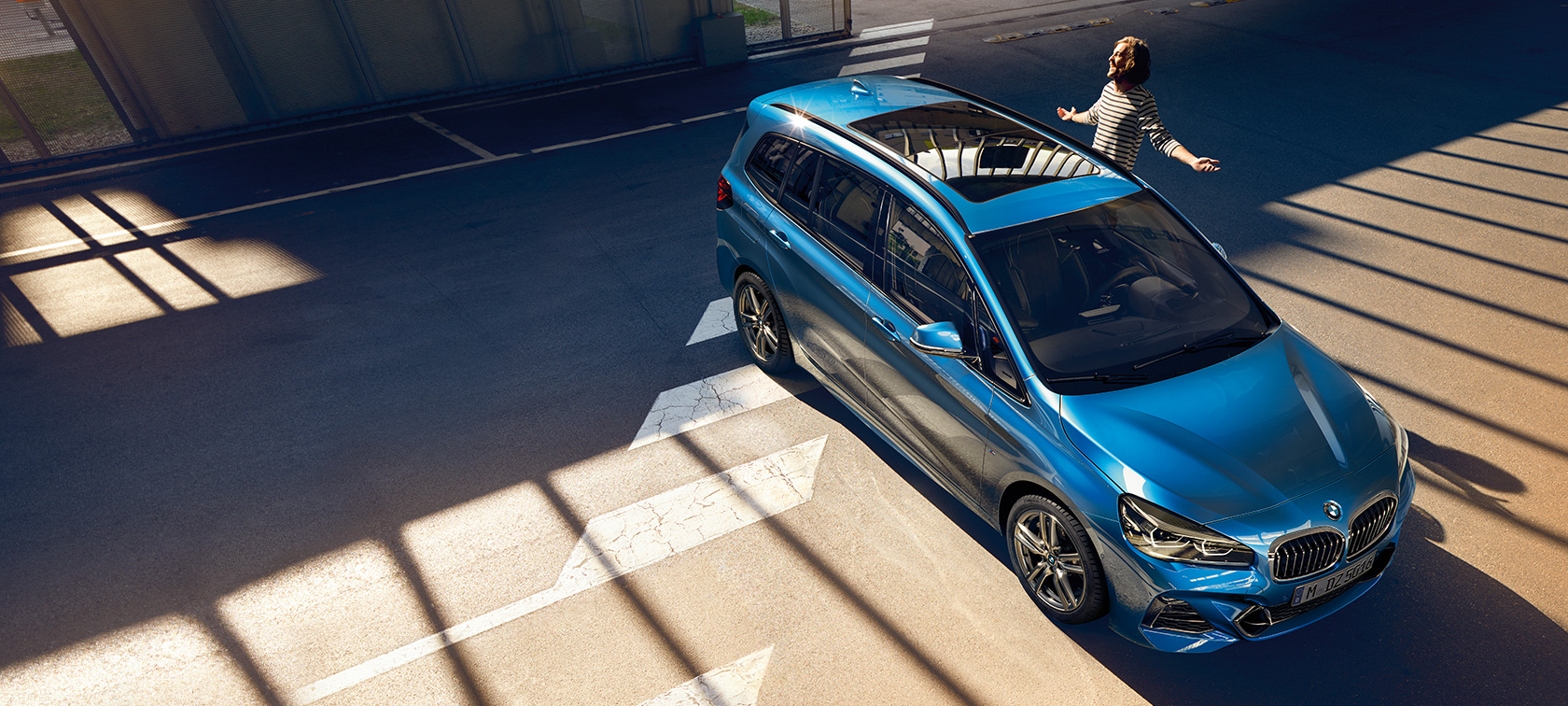 BMW Σειρά 2 Gran Tourer με οικογένεια Οικογένεια στέκεται δίπλα από μία BMW Σειρά 2 Gran Tourer F46 2018, μπλε Misano μεταλλικό