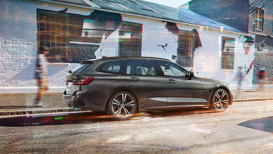 BMW Σειρά 3 Touring (G21), γκρι Dravit, πίσω λήψη 7/8 BMW Σειρά 3 Touring (G21), γκρι Dravit, πίσω λήψη 7/8 σε κίνηση, μπροστά από κτίριο