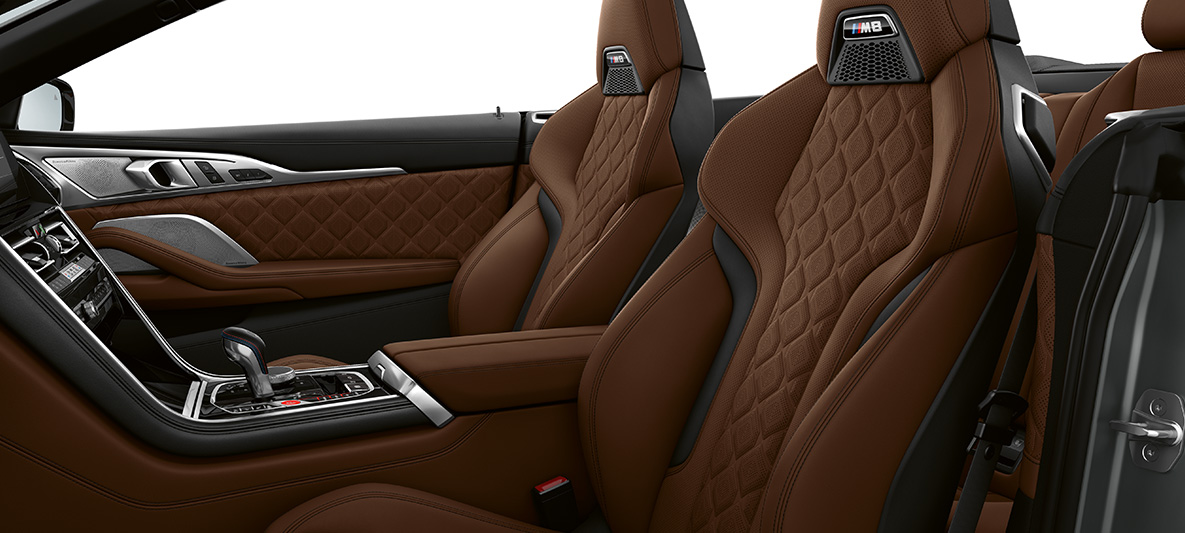 Σπορ καθίσματα Μ με έμβλημα Μ. BMW M8 Cabrio, εσωτερικό με σπορ καθίσματα Μ με δέρμα με λεπτή υφή 'Merino' σε καφέ Taruma.