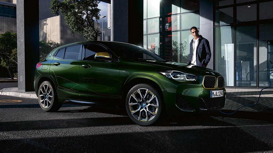 BMW X2 F39, πράσινο Sanremo μεταλλικό, πλαϊνή λήψη τριών τετάρτων με μοντέλο BMW X2 F39, πράσινο Sanremo μεταλλικό, πλαϊνή λήψη τριών τετάρτων με μοντέλο