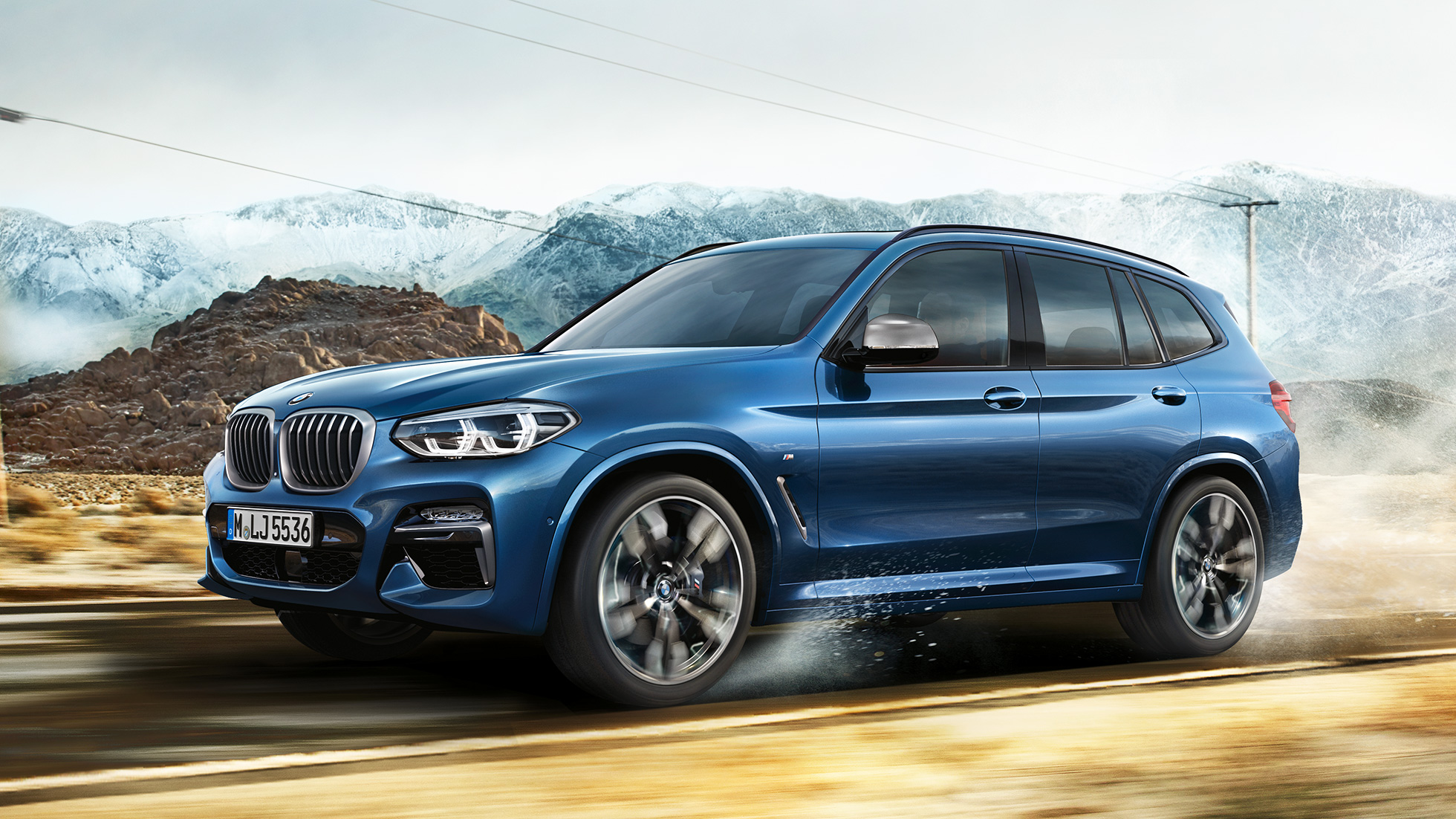 BMW X3 M40i, λήψη ζάντας και μπροστινού προφυλακτήρα μπροστά από ορεινό τοπίο BMW X3 M40i, λήψη ζάντας και μπροστινού προφυλακτήρα μπροστά από ορεινό τοπίο