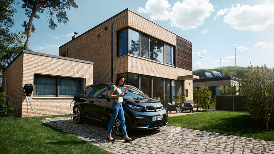 Digital Charging Service Woman using feature “Digital Charging Service“ at home on smartphone for her BMW i3